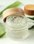 Aloe vera and cosmetics on white background